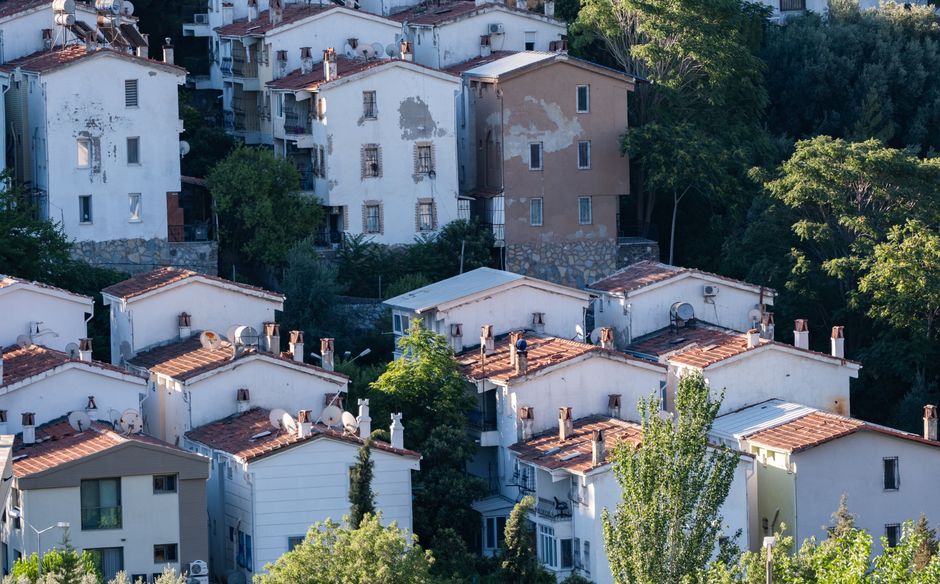 Aerial view of traditional houses in İzmir, Türkiye. Architectural charm in a serene setting.