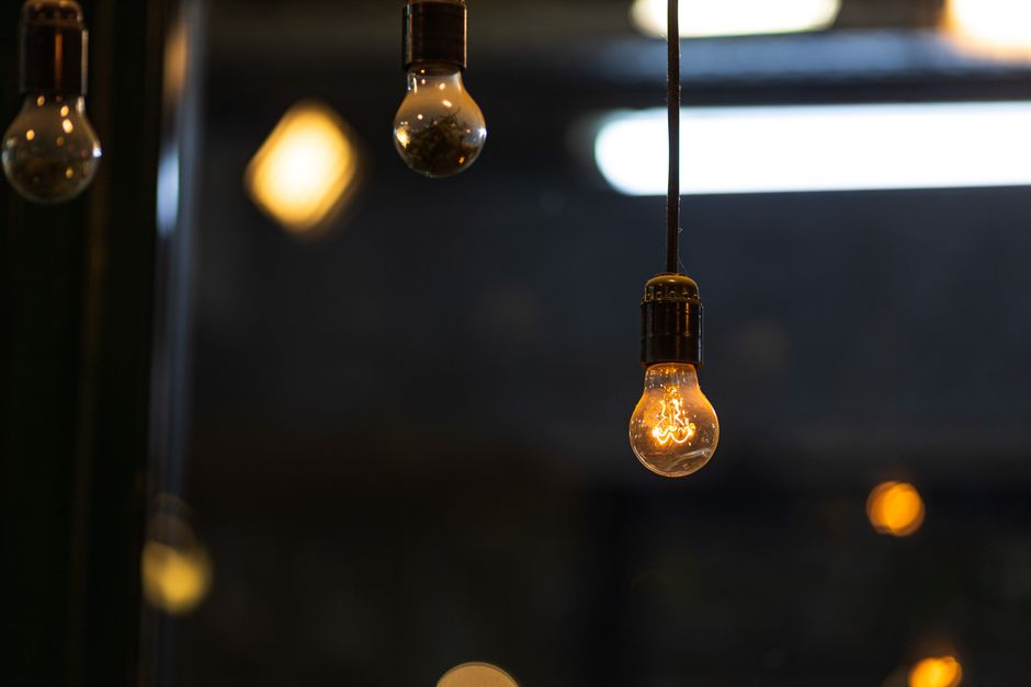 A glowing vintage Edison bulb hanging indoors, creating a warm and cozy ambiance.