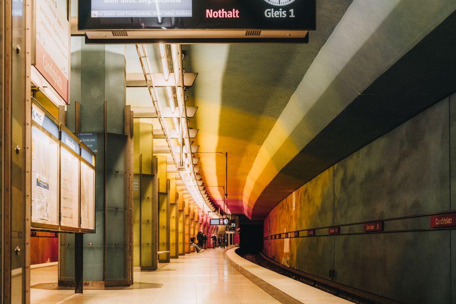 A vibrant urban subway station with a colorful tunnel and platform.