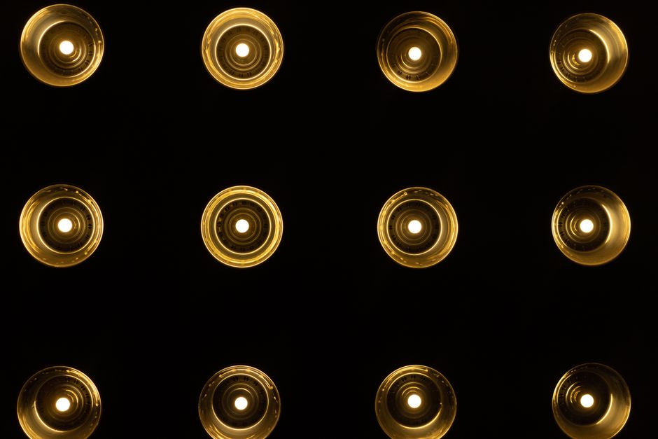 A symmetrical pattern of warm glowing lights set against a dark background, showcasing a creative light design.