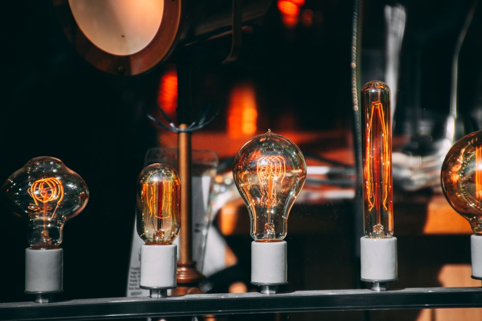 A collection of vintage Edison light bulbs glowing warmly, showcasing intricate filaments.