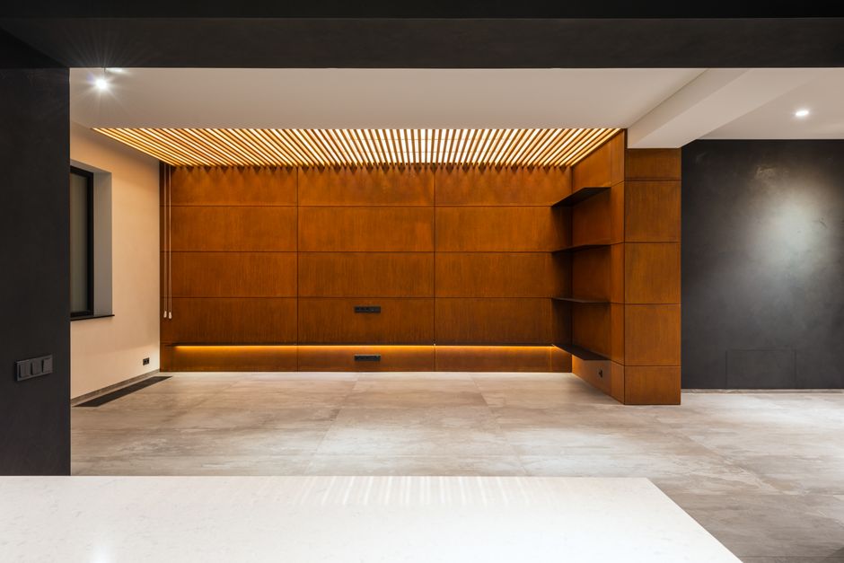 Interior of contemporary hallway with empty shelves and wooden cabinets over marble floor