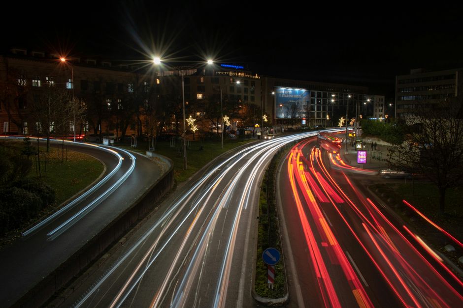 Long exposure shot capturing vibrant night traffic lights in Bratislava's bustling city center.